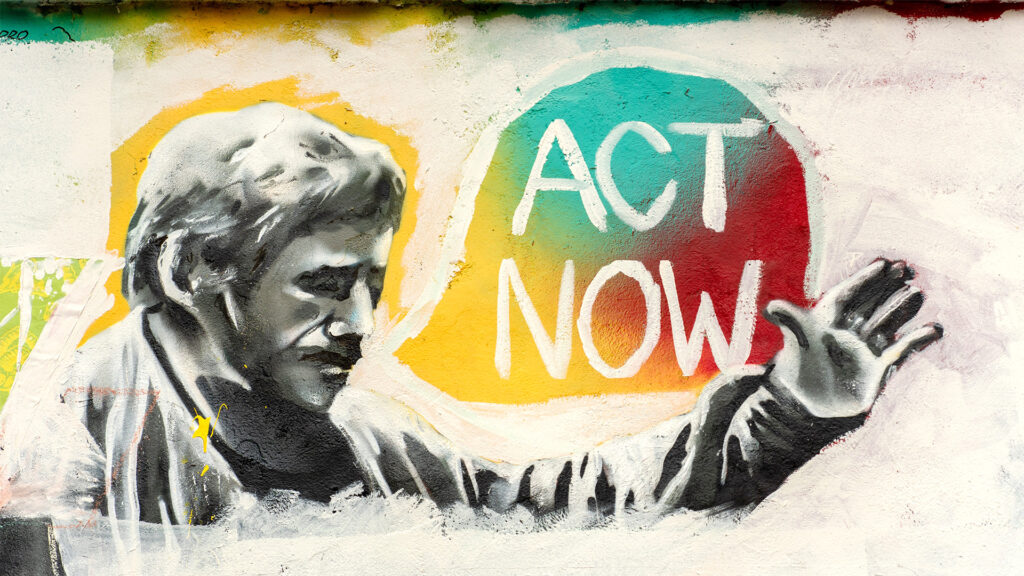 Grafitti auf dem ein Mann "Act now" ruft